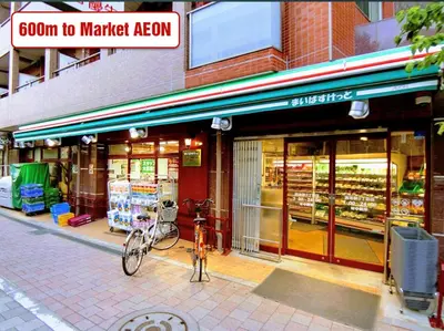 a bike parked in front of a grocery store at Ikebukuro Area R1 NishiikeApartment 5F No Elevator in Tokyo