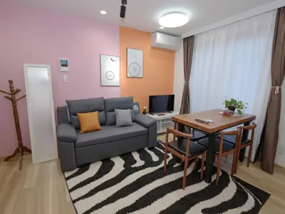 a living room with a couch and a table at City Pal Sakurashinmachi - Vacation STAY 17753 in Tokyo