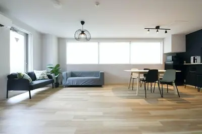 a living room with a table and chairs at Hotel TORAKEN in Tokyo