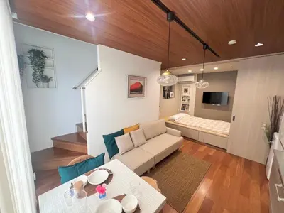 a living room with a couch and a table at Honancho Entire house for rent \u6771\u4eac in Tokyo