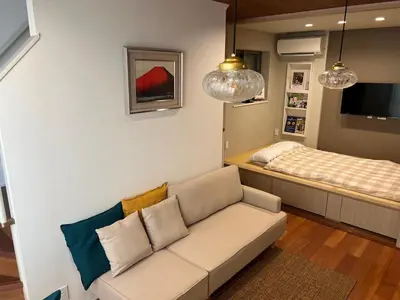 a living room with a couch and a bed at Honancho Entire house for rent \u6771\u4eac in Tokyo