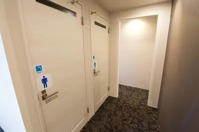 a hallway with a door with a blue sign on it at Aikoku Building 5th floor - Vacation STAY 86252v in Tokyo