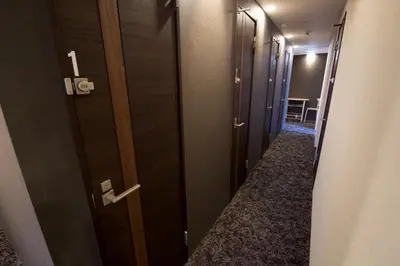 a row of doors in a room with a hallway at Aikoku Building 5th floor - Vacation STAY 86252v in Tokyo