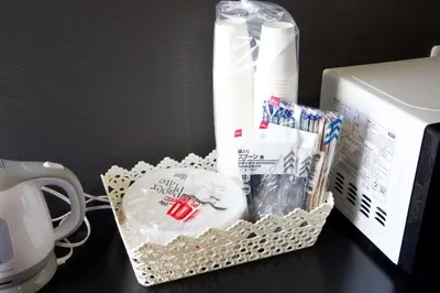 a basket on a desk next to a microwave at Aikoku Building 5th floor - Vacation STAY 86252v in Tokyo