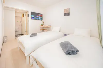 two beds in a room with white walls at \u65b0\u5bbf\u533a\u65b0\u5927\u4e45\u4fdd\u7ad93\u5206\u949f\u7d27\u90bb\u97e9\u56fd\u8857#3 in Tokyo