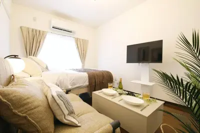 a living room with a couch and a bed at \u30b3\u30fc\u30dd\u3071\u3071\u3069\u308c103 in Tokyo