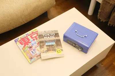 a table with two books and a suitcase on it at \u30b3\u30fc\u30dd\u3071\u3071\u3069\u308c103 in Tokyo