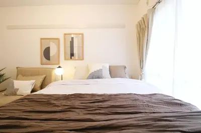 a bedroom with a large bed and a window at \u30b3\u30fc\u30dd\u3071\u3071\u3069\u308c103 in Tokyo
