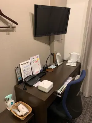 a desk in a hotel room with a television on it at Ochanomizu Inn in Tokyo