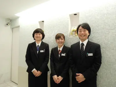 a group of three people in suits posing for a picture at Ochanomizu Inn in Tokyo