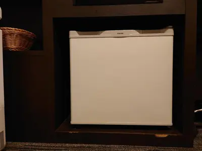 a white refrigerator sitting in a shelf in a room at Ochanomizu Inn in Tokyo