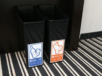 two garbage cans sitting next to a black trash can at APA Hotel Tokyo Nishikasai Ekimae in Tokyo