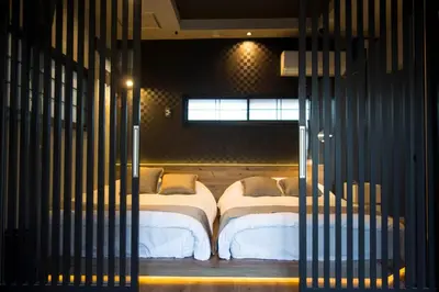 a bedroom with two beds in a room with bars at Tokyo Nook in Tokyo