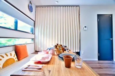 a dining room with a table with dishes on it at Tokyo Nook in Tokyo