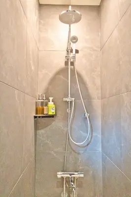 a shower in a bathroom with a shower head at Tokyo Nook in Tokyo