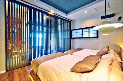 a bedroom with a large bed and a large window at Tokyo Nook in Tokyo