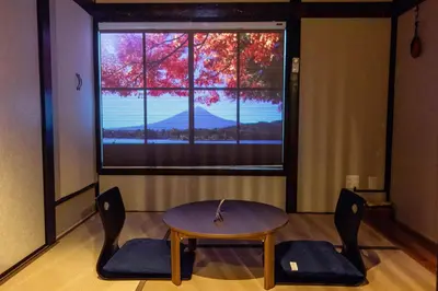 a table and chairs in a room with a window at Tokyo Nook in Tokyo