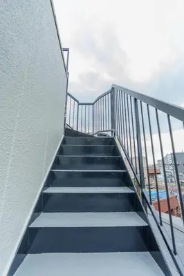 a stairway leading up to the top of a building at \u9759\u5fc3\u5bbf Tranquil Retreat 3F \u6674\u7a7a\u5854Sensoji\u76f4\u8fbe in Tokyo