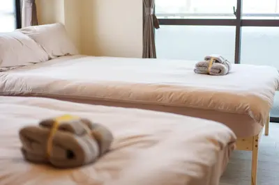 two beds with hats sitting on top of them at \u9759\u5fc3\u5bbf Tranquil Retreat 3F \u6674\u7a7a\u5854Sensoji\u76f4\u8fbe in Tokyo