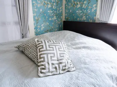 a bed with two pillows on top of it at Shinjuku, 3min walk from Nishi-Shinjuku 5-chome Sta, 3min Shinjuku Sta Switch, Wi-Fi ,Pocketwi-Fi in Tokyo