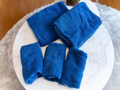 four blue towels on a white plate at Shinjuku, 3min walk from Nishi-Shinjuku 5-chome Sta, 3min Shinjuku Sta Switch, Wi-Fi ,Pocketwi-Fi in Tokyo