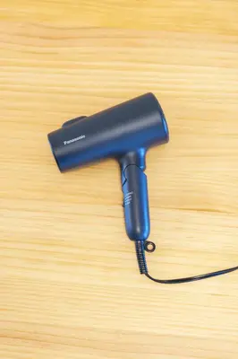a blue blow dryer sitting on a wooden table at \u9759\u5fc3\u5bbf Tranquil Retreat 2F in Tokyo