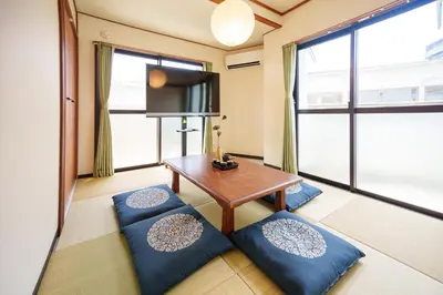 a living room with a table and blue cushions at \u9759\u5fc3\u5bbf Tranquil Retreat 2F in Tokyo