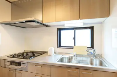 a kitchen with a sink and a stove and a window at \u9759\u5fc3\u5bbf Tranquil Retreat 2F in Tokyo