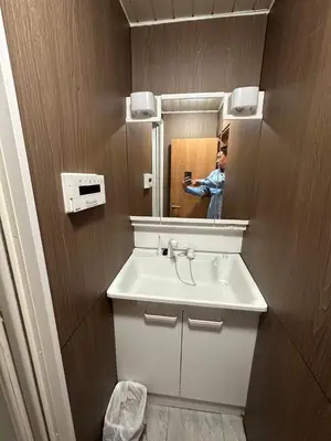 a man taking a picture of a sink in a bathroom at \u82b1\u4e43\u90f7 \u7530\u7aefab in Tokyo