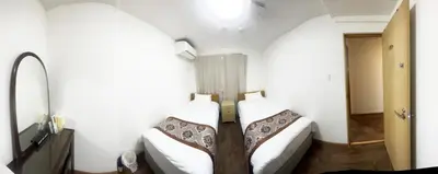 two beds in a small room with white walls at \u82b1\u4e43\u90f7 \u7530\u7aefab in Tokyo