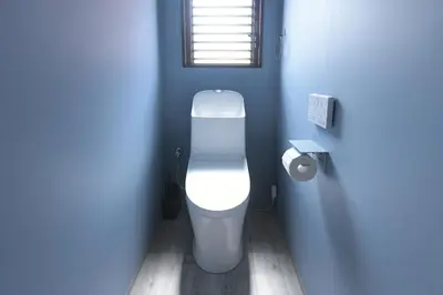 a bathroom with a white toilet in a blue room at Rakuna Inn \u6674 Kinshi2 in Tokyo