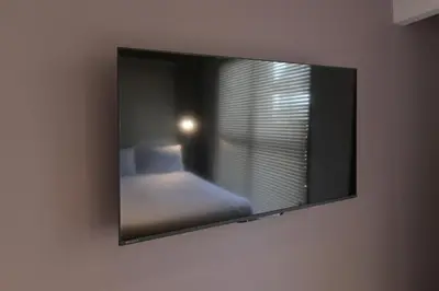 a mirror hanging on a wall in a bedroom at Rakuna Inn \u6674 Kinshi2 in Tokyo