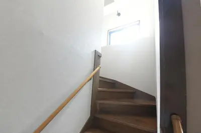 a staircase in a house with white walls and wooden floors at Rakuna Inn \u6674 Kinshi2 in Tokyo