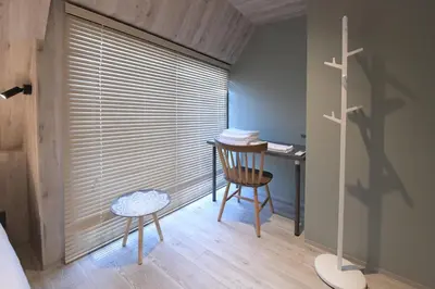 a bedroom with a desk and a chair and a table at Rakuna Inn \u6674 Kinshi2 in Tokyo