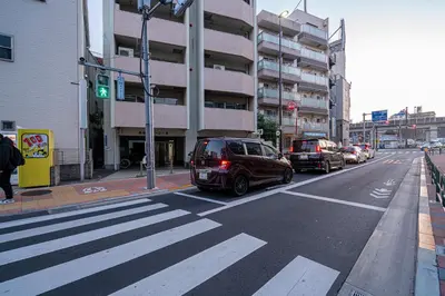 a car is stopped at a crosswalk on a city street at Sakura Suite in Tokyo