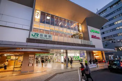 a shopping mall with people walking in front of it at Sakura Suite in Tokyo