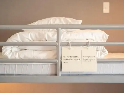 a bunk bed with a sign sitting on it at Super Hotel Premier Akasaka in Tokyo