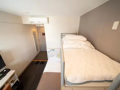 a small room with a bunk bed in it at Super Hotel Premier Akasaka in Tokyo