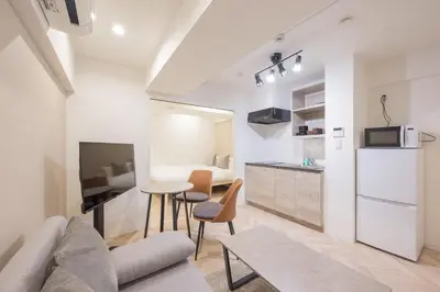 a living room with a couch and a table at CH RESiDENCE \u65e9\u7a32\u7530\u9db4\u5dfb\u753a in Tokyo