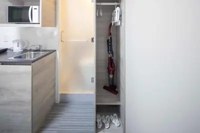 a small kitchen with a sink and a refrigerator at CH RESiDENCE \u65e9\u7a32\u7530\u9db4\u5dfb\u753a in Tokyo