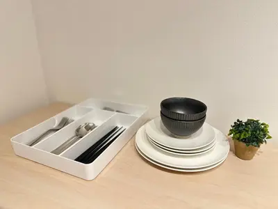 a kitchen sink with plates and a black bowl on top at nestay inn tokyo skytree in Tokyo