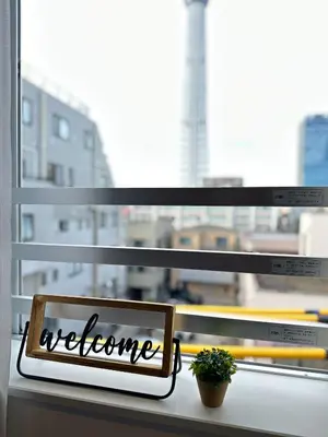 a window with a welcome sign on a window sill at nestay inn tokyo skytree in Tokyo