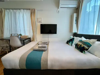 a large bed in a hotel room with a tv at nestay inn tokyo skytree in Tokyo