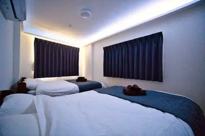 a hotel room with two beds and a window at Tokyo Oasis Heiwajima in Tokyo