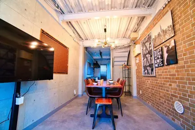 a dining room with a table and chairs and a tv at Tokyo Oasis Heiwajima in Tokyo