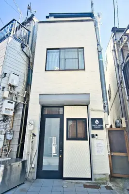 a white building with a door in front of it at Tokyo Oasis Heiwajima in Tokyo