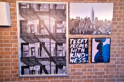 two posters on a brick wall with a city at Tokyo Oasis Heiwajima in Tokyo