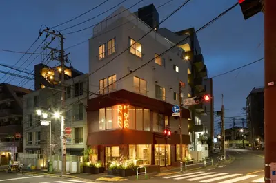a building on a city street at night at SHORTsuido in Tokyo