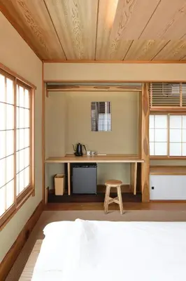a bedroom with a bed and a desk in a room at SHORTsuido in Tokyo