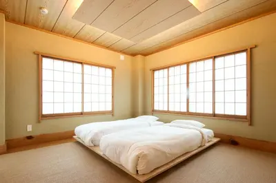 two beds in a room with two windows at SHORTsuido in Tokyo